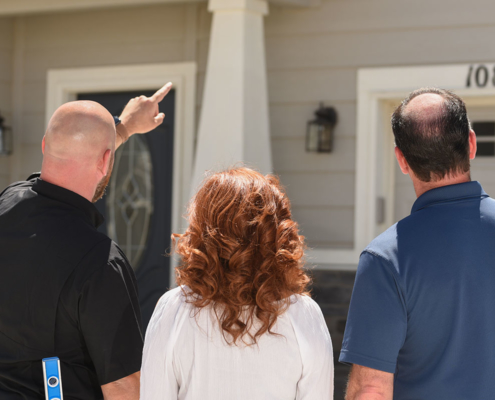 Tom, showing homeowners their home during a home inspection